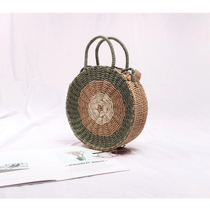 Detail of round straw bag with tri-color concentric circles and drawstring closure