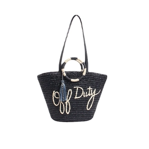 Handwoven black straw tote bag with Off Duty text, dual handles and blue tassel detail