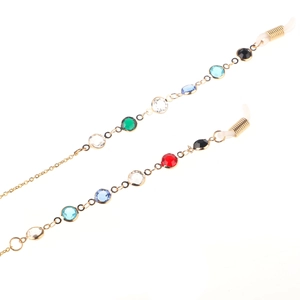 Detail of gold glasses chain with colorful crystal beads and silicone loop connectors