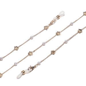 Detail of gold eyewear chain with small pearls, star charms and adjustable rubber loops
