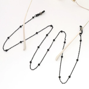 Minimalist black beaded eyewear chain with adjustable anti-slip rubber loops for glasses