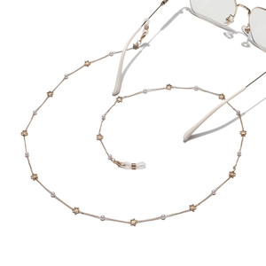 Detail of gold star and pearl eyewear chain with secure silicone loop attachments