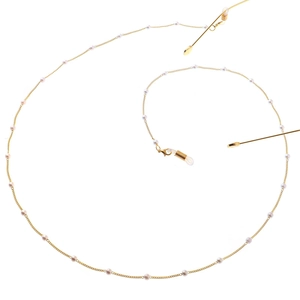 Detailed view of gold pearl eyewear chain with anti-slip silicone loops and lobster clasps