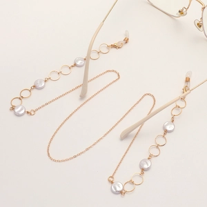 Elegant gold metal eyeglass chain featuring round links and white pearl accents on white base