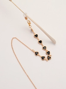 Detail of golden chain with black heart pendants and silicone anti-slip loops