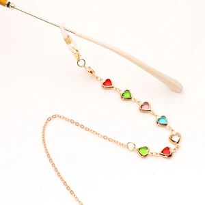 Detail of gold chain with colorful heart crystals and adjustable silicone eyeglass loops
