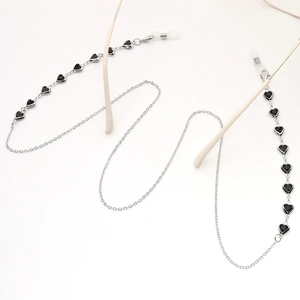 Detailed view of silver chain glasses strap with black heart charms on eyeglass temple