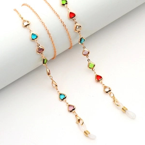 Golden metal eyewear chain featuring colorful heart crystal charms and silicone loops