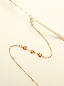 Detail of rose gold daisy glasses chain with red and yellow enamel flower charms