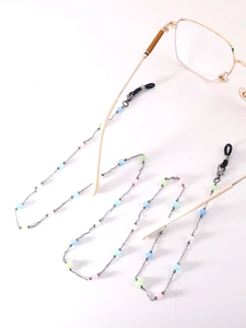 Close-up of pastel beads and metal chain for glasses with black silicone connectors