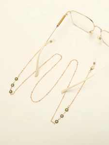 Detail of golden glasses chain with black daisy charms and silicone loop connectors