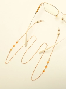 Detail of golden metal eyewear chain with colorful daisy charms and silicone loops