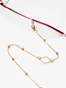 Golden eyewear chain with geometric diamond pendant and beads on thin metal link strap