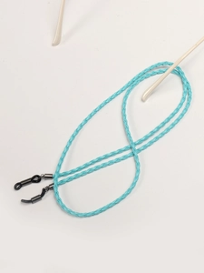 Close-up of light blue braided eyewear retainer cord with black adjustable rubber ends