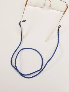 Detail of royal blue braided eyewear strap with black silicone loops and metal spring