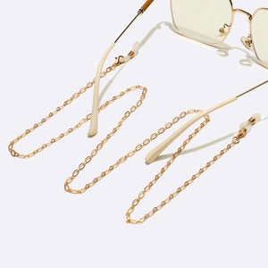 Golden anti-slip sunglasses chain with silicone loops and lobster clasps on white background