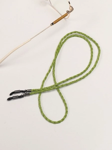 Detail of green braided leather eyeglass chain with adjustable non-slip rubber loops