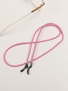 Close-up of pink woven eyewear chain with adjustable rubber ends and metal spring detail