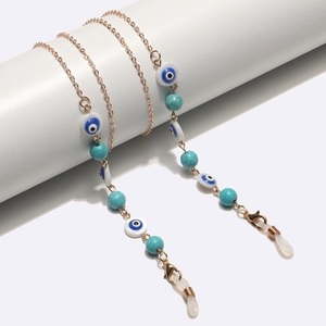 Golden eyewear chain featuring turquoise beads and evil eye charms with silicone loops