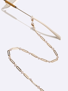 Elegant gold metal chain with white pearls and silicone loops for eyeglasses and masks