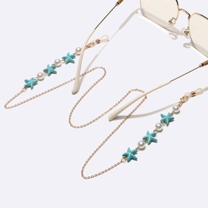 Gold glasses chain with blue starfish and pearls on minimalist eyeglasses frame