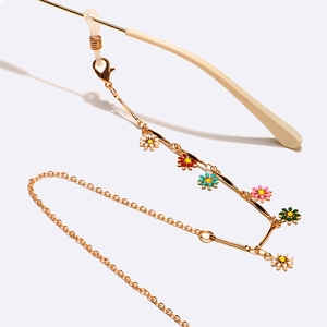 Chaîne de lunettes dorée avec marguerites colorées en émail et boucles de fixation sûres