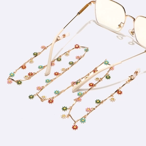 Golden metal eyewear chain featuring colorful enamel daisy charms and adjustable loops
