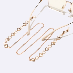 Elegant gold heart link glasses chain with adjustable silicone loops on a white surface