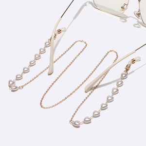 Golden eyewear chain with heart-shaped pearls and silicone loops on clear glasses