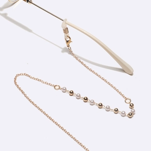 Elegant gold metal eyewear chain with white pearls and polished beads on white background