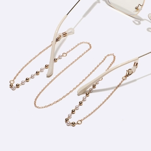 Elegant gold metal eyewear chain featuring white pearls and beads on a clean white background