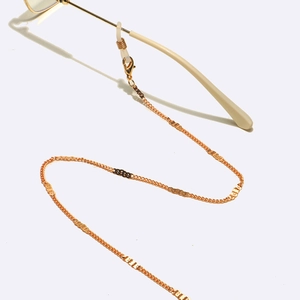 Golden metal eyewear chain with rectangular plates and anti-slip silicone loops