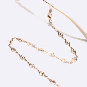 Golden eyewear chain with hollow diamond links featuring love text and silicone loops