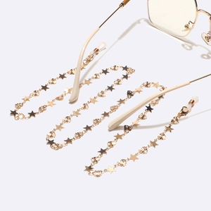 Golden handmade glasses chain featuring celestial star and engraved heart metal charms