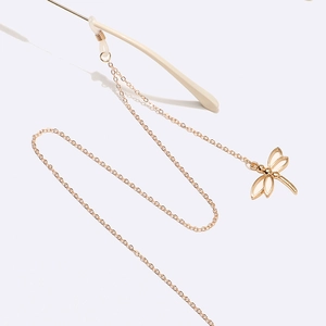 Golden dragonfly eyewear chain with white enamel details and silicone anti-slip connectors