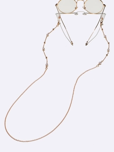 Détail de chaîne de lunettes dorée avec perles élégantes et boucles en silicone réglables