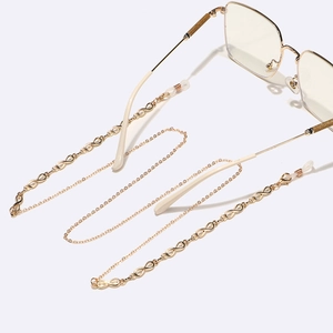 Golden infinity symbol eyewear chain with adjustable silicone loops on metal glasses