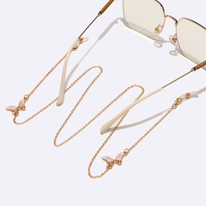 Chaîne de lunettes dorée avec pendentifs papillons en strass et perles sur monture d'or