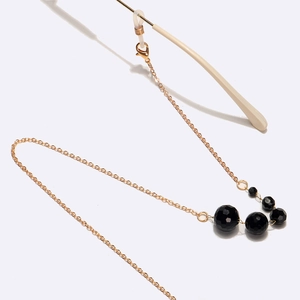 Chaîne de lunettes dorée avec perles de cristal noir facettées et boucles en silicone