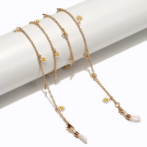 Handmade gold eyewear chain featuring white daisy enamel pendants and silicone loops