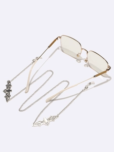 Silver eyewear chain with hollow bat pendants and anti-slip loops on white background