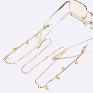Gold metal eyewear chain with white daisy charms and adjustable silicone loops