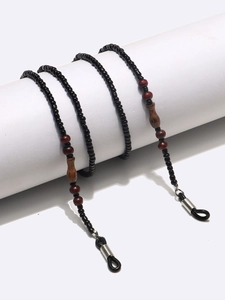 Handmade eyeglass chain with black and mahogany beads on a white display stand