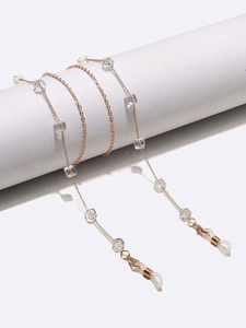 Golden eyewear chain featuring square clear crystals and white silicone anti-slip loops