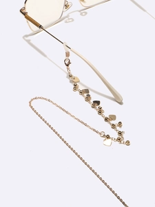 Golden eyewear chain with heart pendants and rhinestones on glasses for women