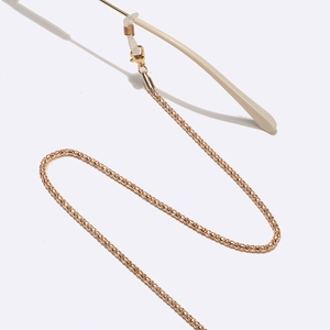 Detail of 2.4mm golden ball chain eyewear strap with lobster clasp and silicone loop