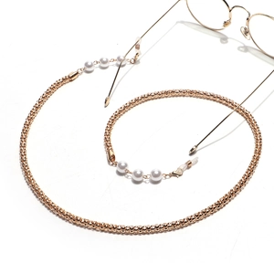 Detail of gold beaded eyewear chain with white pearls and adjustable rubber loops