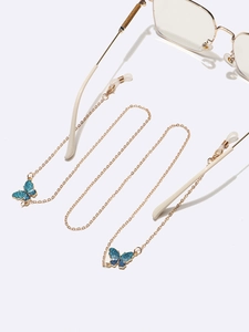 Chaîne de lunettes dorée style punk avec des pendentifs papillon bleu foncé scintillants