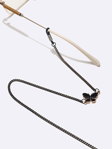 Chaîne de lunettes en métal noir avec un élégant pendentif papillon en strass