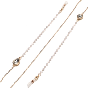 Detail of gold eyewear chain featuring white pearls and teardrop crystal pendants